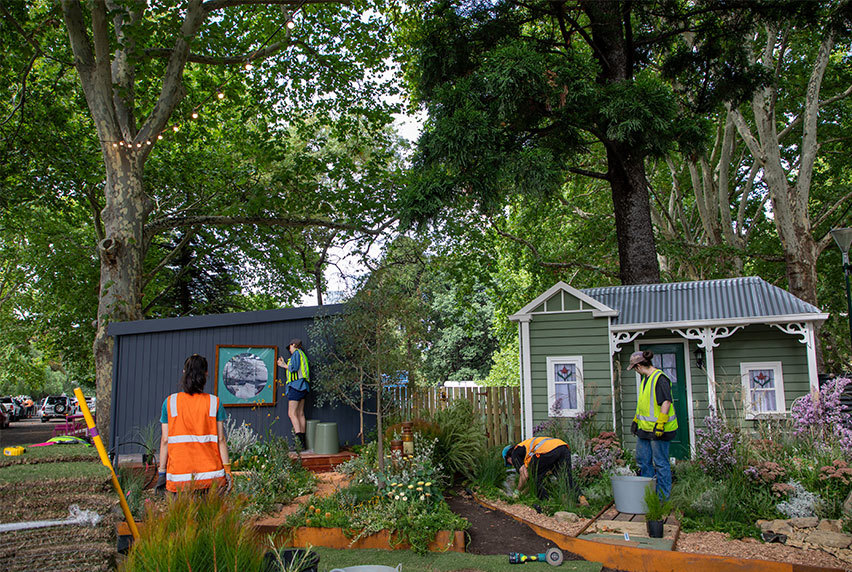 Students in high-visibility clothing constructing the “Throwing Shapes” and “Afterrain” gardens.