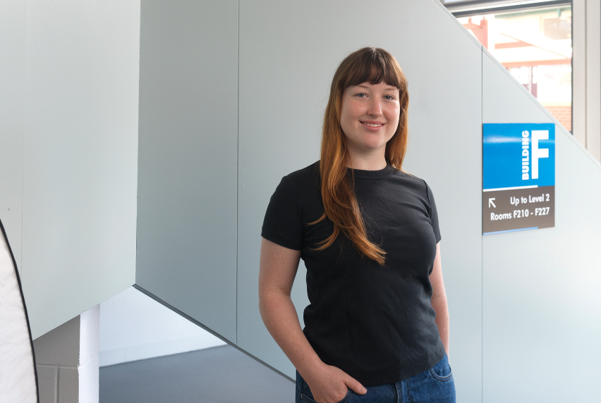 Person smiling while wearing a black T-shirt.