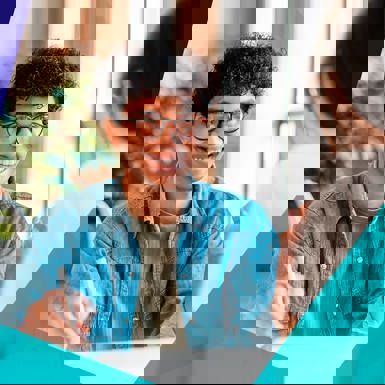 Smiling young student speaking with a career counsellor at a desk